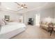 Large main bedroom features a tray ceiling, sitting area, and doorway to the ensuite at 2728 Cameron Pond Dr, Cary, NC 27519