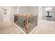 Foyer staircase with decorative metal railing and neutral carpeting at 2728 Cameron Pond Dr, Cary, NC 27519