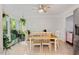 Bright dining area features a ceiling fan and large windows overlooking the lush yard at 307 Durington Pl, Cary, NC 27518
