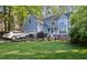 Charming two-story home with light blue siding, well-maintained lawn, and an attached two-car garage at 307 Durington Pl, Cary, NC 27518