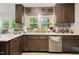 Beautiful kitchen featuring dark wood cabinets, stainless steel appliances, and quartz countertops at 307 Durington Pl, Cary, NC 27518