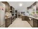 Modern kitchen features dark wood cabinets, stainless steel appliances, and granite countertops at 307 Durington Pl, Cary, NC 27518