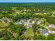 An aerial view of a neighborhood featuring tree-lined streets and various home styles at 311 Ocean Dr, Clayton, NC 27520