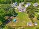 Aerial view of a large backyard with a fenced perimeter, mature trees, and shed at 311 Ocean Dr, Clayton, NC 27520
