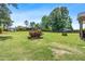 A large, landscaped backyard featuring a well-manicured lawn and a decorative fire pit at 311 Ocean Dr, Clayton, NC 27520