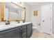 Bathroom features a dual sink vanity with marble countertop, framed mirror, and tile flooring at 311 Ocean Dr, Clayton, NC 27520