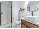 Modern bathroom featuring shiplap walls, a vessel sink, and a walk-in shower with glass door at 311 Ocean Dr, Clayton, NC 27520