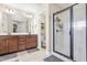 This bathroom offers a double vanity, wood cabinets and a modern glass shower at 311 Ocean Dr, Clayton, NC 27520