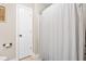 This bathroom features a white shower curtain, neutral wall color, and a tiled floor at 311 Ocean Dr, Clayton, NC 27520