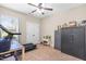 Bedroom showcasing a treadmill, two gun safes, neutral carpeting, and natural lighting at 311 Ocean Dr, Clayton, NC 27520