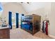 This bedroom has a wooden bunk bed with blue bedding and curtains at 311 Ocean Dr, Clayton, NC 27520