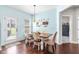 Bright dining area with hardwood floors, wooden table, and natural light from the glass patio door at 311 Ocean Dr, Clayton, NC 27520