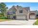 Traditional two-story home with a two car garage, a basketball hoop, and well-maintained landscaping at 311 Ocean Dr, Clayton, NC 27520