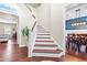 Bright foyer with hardwood floors and stairs leading to the second floor and views into other rooms at 311 Ocean Dr, Clayton, NC 27520