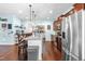 Open kitchen featuring stainless steel appliances, granite counters, an island, and hardwood floors at 311 Ocean Dr, Clayton, NC 27520