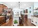 Well-equipped kitchen featuring cherry cabinets, granite counters, stainless appliances, and hardwood floors at 311 Ocean Dr, Clayton, NC 27520