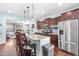 This kitchen features stainless steel appliances, granite countertops, and an island with barstool seating at 311 Ocean Dr, Clayton, NC 27520