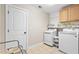Clean laundry room with front-load washer and dryer, shelving, and ample storage at 311 Ocean Dr, Clayton, NC 27520