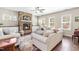 Cozy living room featuring a stone fireplace, neutral furniture, hardwood floors, and plenty of natural light at 311 Ocean Dr, Clayton, NC 27520