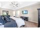 The main bedroom has a tray ceiling, tv and matching dark colored furniture at 311 Ocean Dr, Clayton, NC 27520