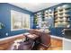 Beautiful office with blue walls, built-in shelves, hardwood floors, and a large window for natural light at 311 Ocean Dr, Clayton, NC 27520