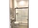 Modern bathroom featuring a glass-enclosed shower with gray tile, a sleek vanity and modern fixtures at 3521 Olive Glen Dr, Apex, NC 27502