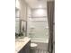 This bathroom includes a shower and bath combo, patterned floors, and granite countertops at 3521 Olive Glen Dr, Apex, NC 27502