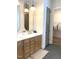Bathroom featuring double sink vanity with gold accents, large mirrors and tile flooring at 3521 Olive Glen Dr, Apex, NC 27502