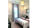 Cozy bedroom with a dark metal bed frame, neutral-toned walls, and a window for natural light at 3521 Olive Glen Dr, Apex, NC 27502