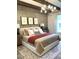 Stylish bedroom with wainscotting, decorative ceiling beams, a cozy bed, and patterned rug at 3521 Olive Glen Dr, Apex, NC 27502