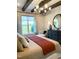 Bright bedroom with decorative ceiling beams, a cozy bed, and a large window with great views at 3521 Olive Glen Dr, Apex, NC 27502