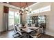 Elegant dining room with stylish chandelier, hardwood floors, and display cabinet with glass doors at 3521 Olive Glen Dr, Apex, NC 27502