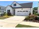 Charming home featuring a two-car garage, well-maintained landscaping, and classic white siding at 3521 Olive Glen Dr, Apex, NC 27502