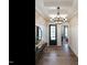 Elegant entryway with hardwood floors, decorative wallpaper, stylish lighting, and a front door at 3521 Olive Glen Dr, Apex, NC 27502