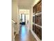 Hallway with hardwood floors, decorative wall art, and a view of the front door at 3521 Olive Glen Dr, Apex, NC 27502