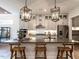 Modern kitchen island with seating, stainless steel appliances, and pendant lighting at 3521 Olive Glen Dr, Apex, NC 27502