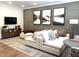 Spacious living room with contemporary decor, featuring a sectional sofa, modern artwork, and recessed lighting at 3521 Olive Glen Dr, Apex, NC 27502
