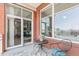 Balcony with bistro set, brick facade, and sliding glass doors offering city views at 400 W North St # 1134, Raleigh, NC 27603