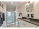 Bathroom featuring tiled shower, granite countertop and neutral color palette at 400 W North St # 1134, Raleigh, NC 27603
