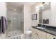 Bathroom featuring tiled shower and granite countertop at 400 W North St # 1134, Raleigh, NC 27603