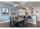 Bright dining space with a modern table, open to a kitchen area featuring white cabinetry and bar seating at 400 W North St # 1134, Raleigh, NC 27603