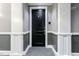 Hallway with modern carpeting and elegant gray wall trim, showcasing apartment door at 400 W North St # 1134, Raleigh, NC 27603