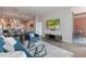Open concept living area with a modern sofa, leading to a kitchen and a balcony offering city views at 400 W North St # 1134, Raleigh, NC 27603