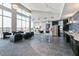 Spacious lounge area with modern seating, kitchen amenities, and large windows at 400 W North St # 1134, Raleigh, NC 27603