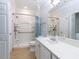 Bright bathroom with a spacious shower featuring grab bars and a modern sink with ample counter space at 412 Waterford Lake Dr, Cary, NC 27519