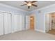 Spacious light blue bedroom with neutral carpet and three closets, leading to dining and bathroom areas at 412 Waterford Lake Dr, Cary, NC 27519
