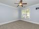 Light blue bedroom with neutral carpet, white trim, ceiling fan, and exterior view at 412 Waterford Lake Dr, Cary, NC 27519