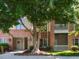 Charming condo building with brick facade, outdoor spaces, and mature trees at 412 Waterford Lake Dr, Cary, NC 27519