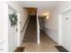 Hallway with tile flooring, a staircase, and white trim highlighting the entrance to residential units at 412 Waterford Lake Dr, Cary, NC 27519