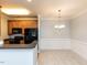 Eat-in kitchen features black appliances, hardwood cabinets, granite countertops and chandelier lighting in dining area at 412 Waterford Lake Dr, Cary, NC 27519